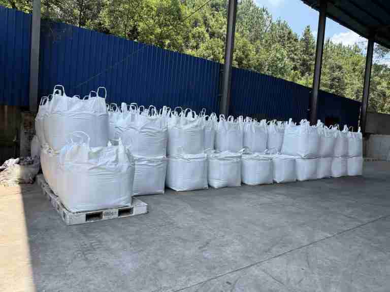 Jumbo bags of lignosulfonate in covered storage