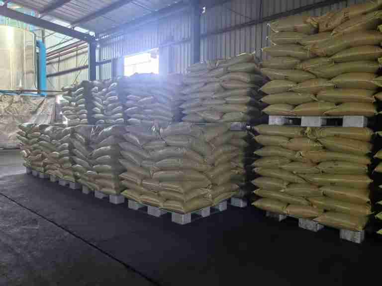 Rows of palletized lignosulfonate bags in the warehouse